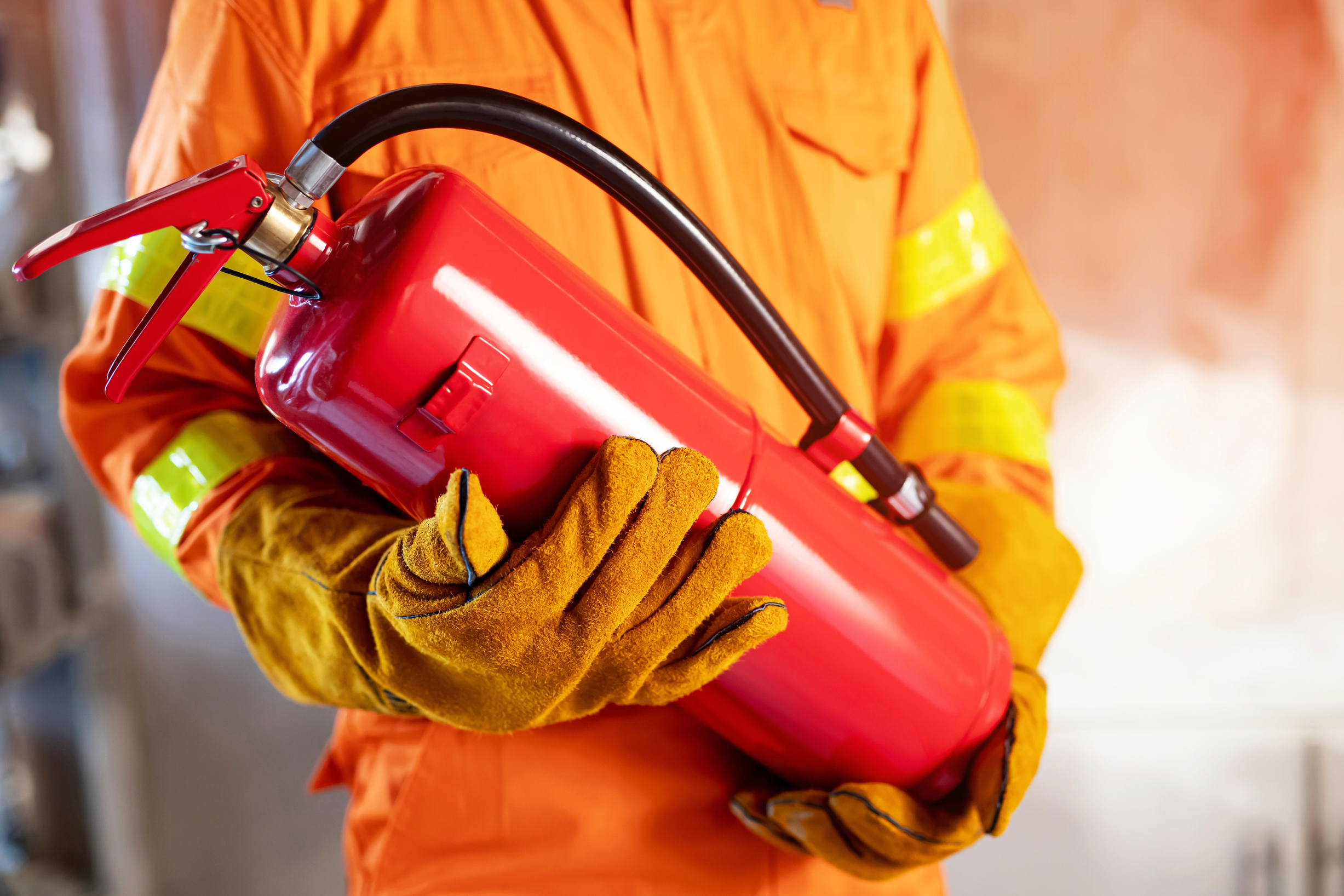 Fireman Holding Fire Extinguishers